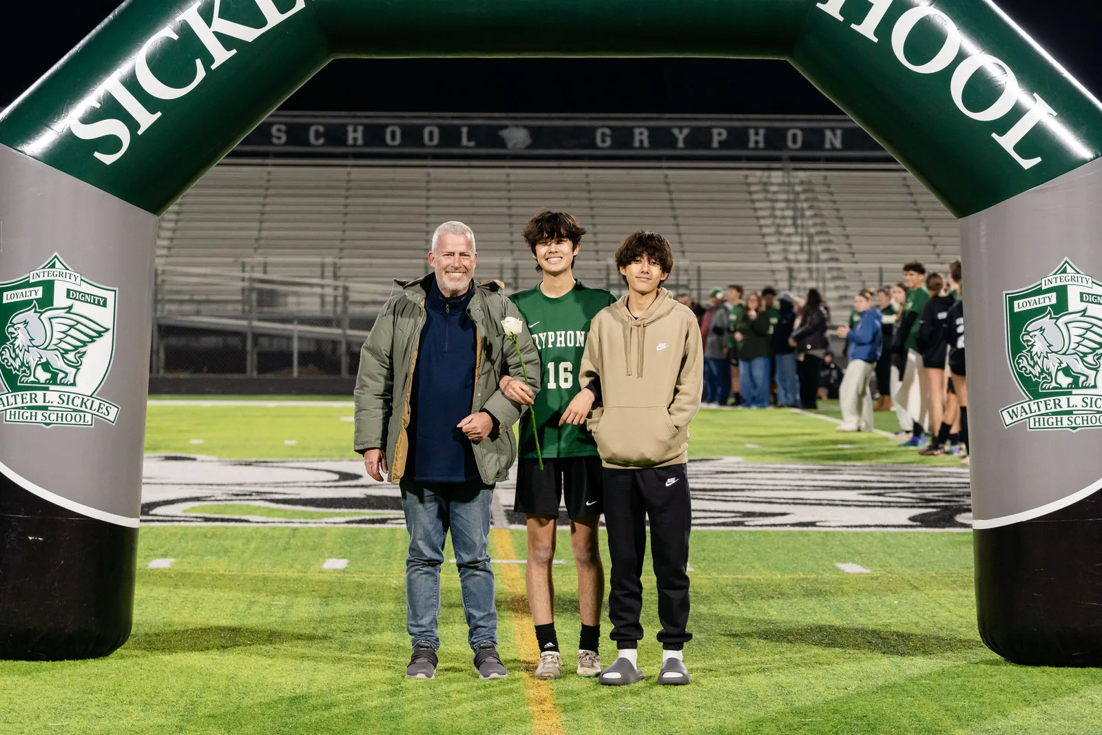 jaime with family on the soccer field at senior night