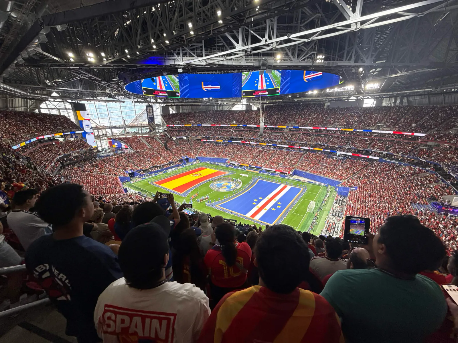 a packed soccer stadium viewed from the stands